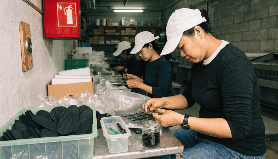 A smaller, newer factory in Vietnam with workers assembling shoe components
